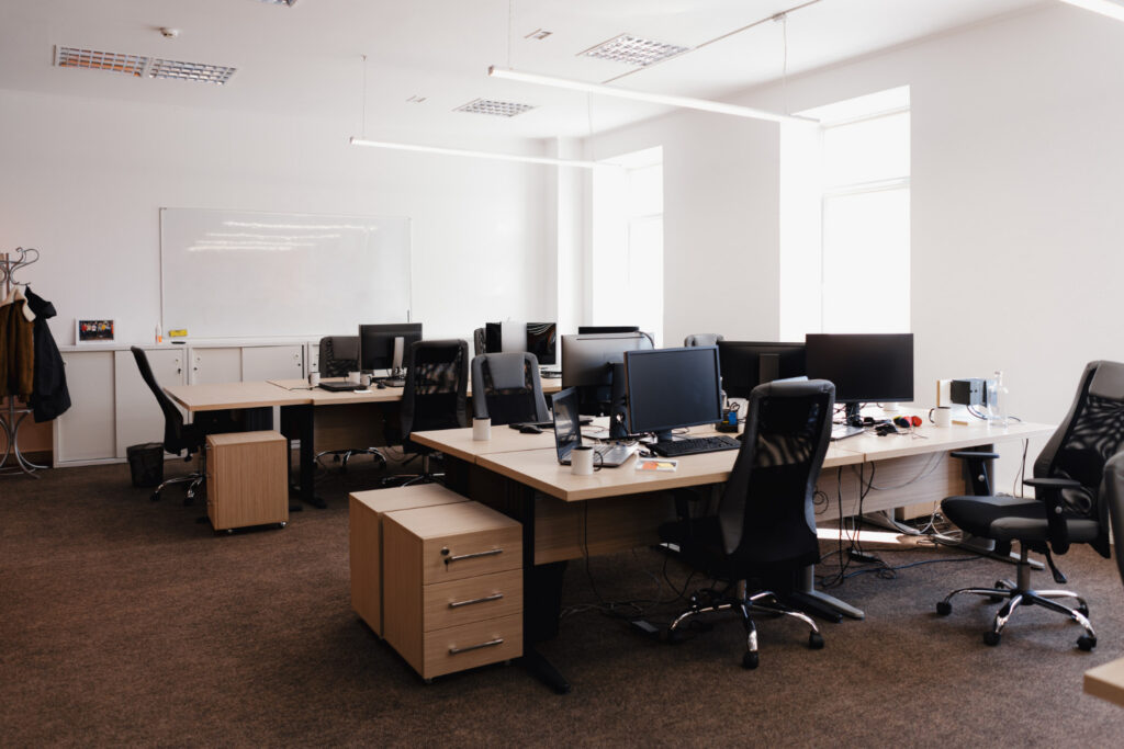 Modern office workspace with desks and computer monitors