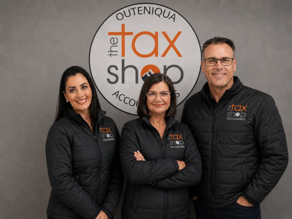 The Tax Shop Outeniqua team standing in front of the company logo